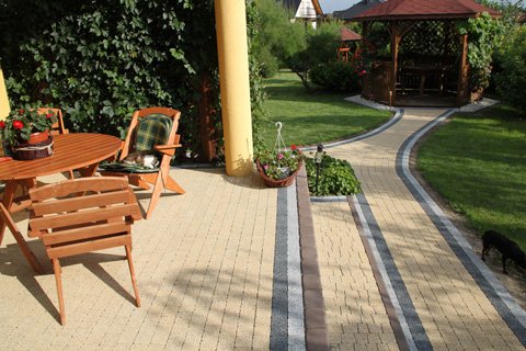 brick walkway and a wooden table with chairs